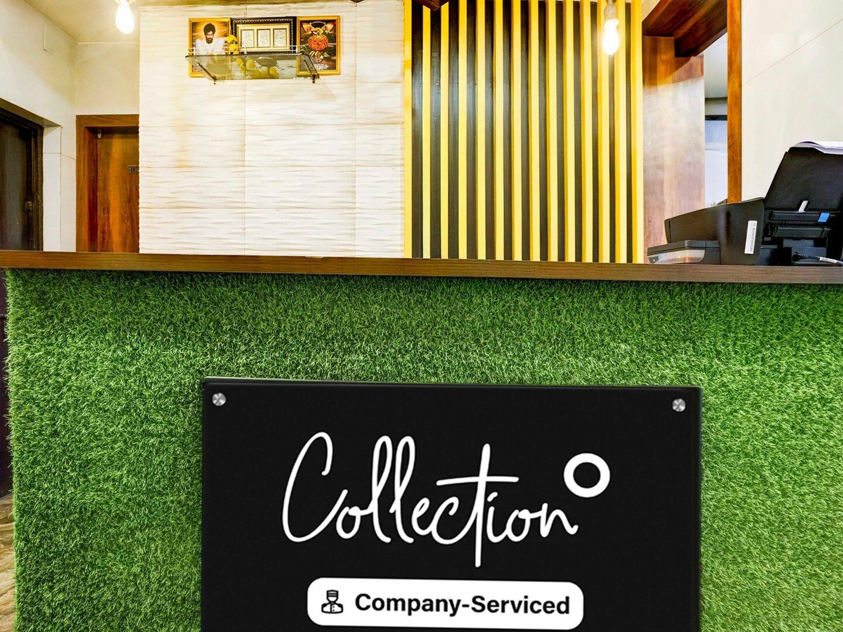 A reception desk with a sign indicating 'Collection' and 'Company-Served'.