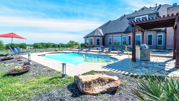 A backyard with a swimming pool, lounge chairs, and a pergola. - Charming farmhouse in Countryside with Pool & great views for 16 guests  (Ponder)