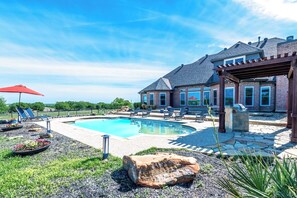 A backyard with a swimming pool, lounge chairs, and a pergola. - Charming farmhouse in Countryside with Pool & great views for 16 guests  (Ponder)