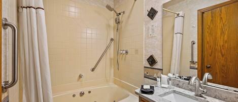 A bathroom with a bathtub, shower, and sink.