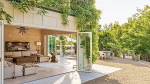 An open-plan living area with a wooden ceiling, a sofa set, a coffee table, and a decorative car model. - Kenwood Lodge - 5 Bedroom/En-suite, Heated Pool (Kenwood)