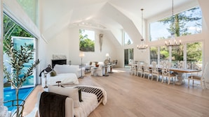 A spacious living area with a dining table, chairs, and a fireplace. - Kenwood Lodge - 5 Bedroom/En-suite, Heated Pool (Kenwood)