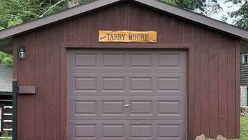 A wooden garage with a sign reading 'Tarry Moore' above the door.
