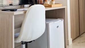 A modern office space with a desk, chair, computer, and a small refrigerator. - Nerisa home  (Naples)