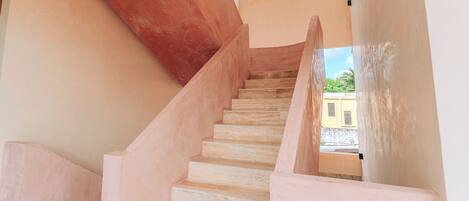 A staircase with a modern design, leading to an outdoor area.