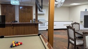 A pool table with balls, a wooden bar, and a dining area with chairs. - Bedrooms for rent in a very nice space (Joplin)