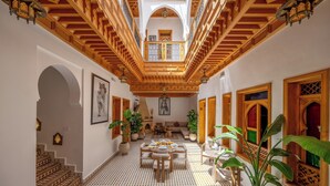 A spacious interior with a high ceiling, a central seating area, and a patterned floor. - Riad Al Ghazlan  (Marrakech)