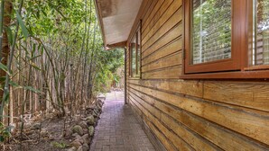 A wooden building with a brick pathway leading to a gate. - Gorgeous home in Erm with WiFi (Erm)