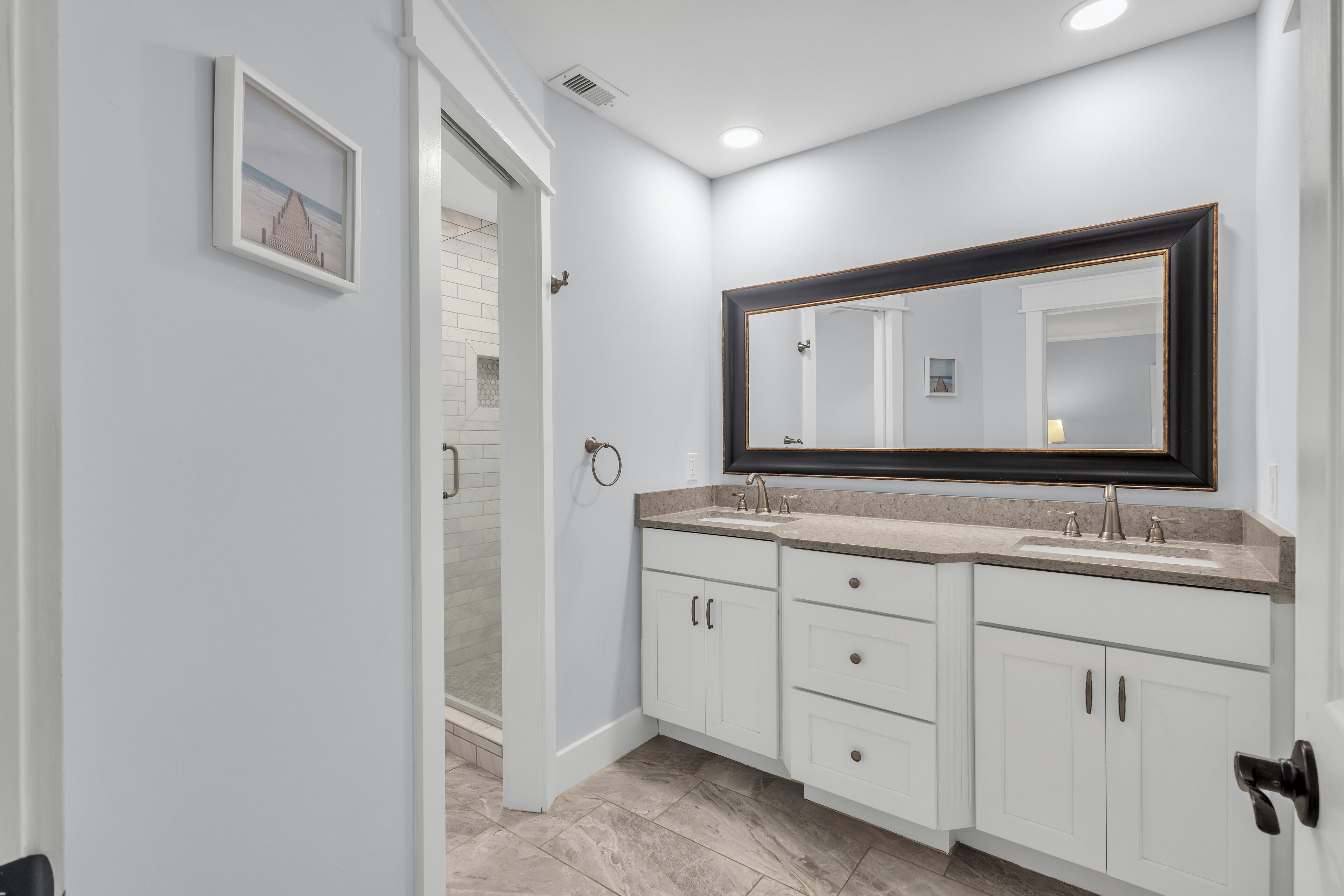 Bedroom 1: King Primary suite, en-suite bathroom with double vanity and walk-in shower, Smart TV, access to backyard patio