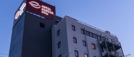 A hotel building with a prominent sign on the side.