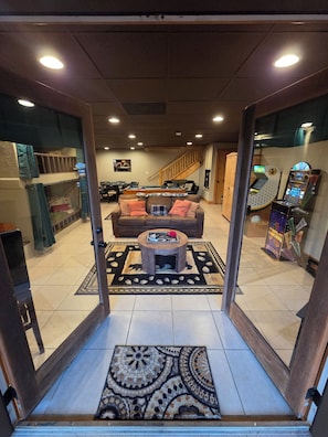 A room with a pool table, a sofa, and a coffee table. There is a staircase leading to another level. - FamiLee RosenHütte 
4BR 4BA Cabin in- Innsbruck Helen GA 
W-HotTub&DogFriendly  (Helen)