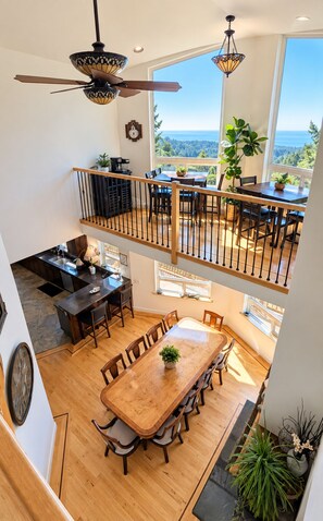 A spacious dining area with a high ceiling and a view of the outdoors.