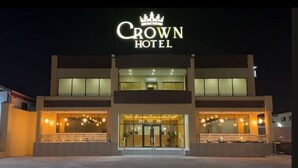 A hotel named "Crown Hotel" with a modern facade, large glass windows, and a welcoming entrance. - CROWN HOTEL GUYANA INC (Georgetown)