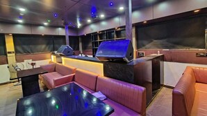 A modern lounge area with leather seating, a bar counter, and ambient lighting. - Hotel MKG Inn Club and Bar Jaipur (Jaipur)