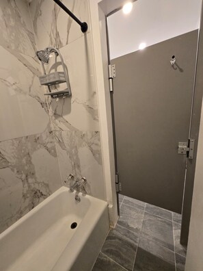 Combined shower/tub, hair dryer, slippers, towels