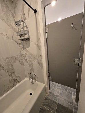 Combined shower/tub, hair dryer, slippers, towels