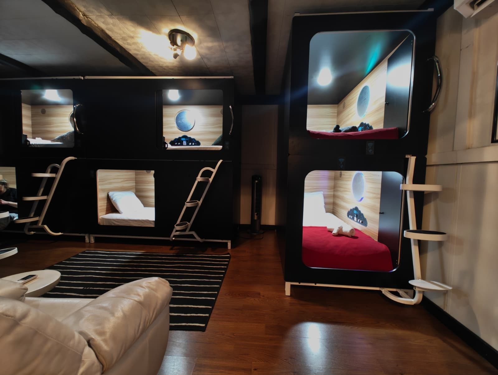 A room with bunk beds, a desk, and a chair.