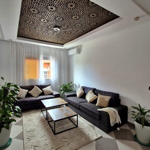 A modern living room with a sectional sofa, a coffee table, and decorative pillows.