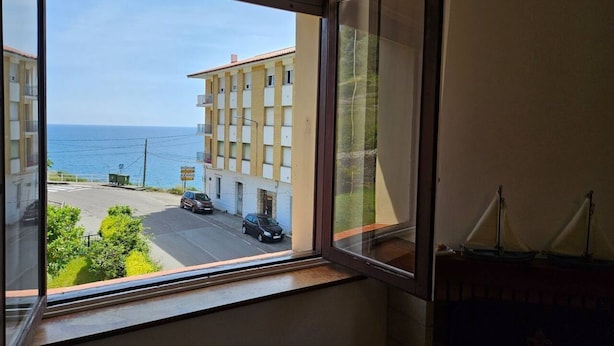 A window with a view of a building and a street.