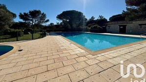 A swimming pool with a clear blue sky and sunlight.