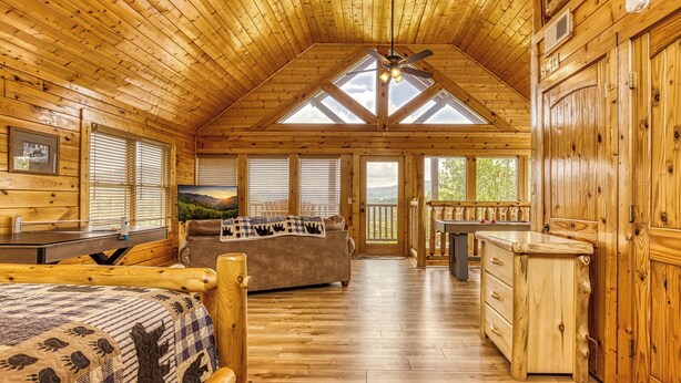 A log cabin interior with a loft bedroom, a dining area, and a kitchen. - Panoramic View-Pigeon Forge Two Bedroom Plus Loft Cabin Rental-Swimming Pool (Sevierville)