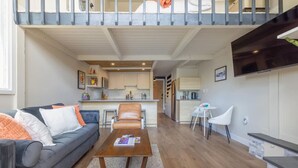 A modern apartment with a living room, kitchen, and dining area. - Modern Condo with Vail Mountain Views (Vail)