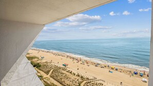 Vista al mar desde un balcón, con cielo despejado y mar tranquilo.