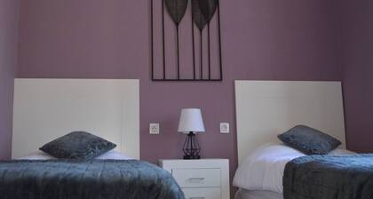 This twin room has two single beds with a private separate bathroom ( bathroom across the hallway). The view is of the whole garden area and the sea can be seen on clear days.