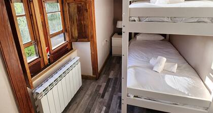 This room is a bunk room with two single bunk beds. The bathroom and showers are shared with the two other bunk rooms . The room has a great view of the village square.