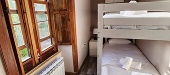 This room is a bunk room with two single bunk beds. The bathroom and showers are shared with the two other bunk rooms . The room has a great view of the village square.