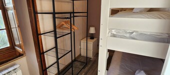This room is a bunk room with two single bunk beds. The bathroom and showers are shared with the two other bunk rooms . The room has a great view of the village square.