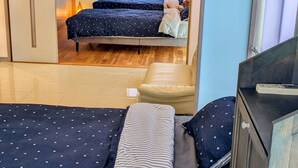 A compact room with a bunk bed, a desk, and a chair.