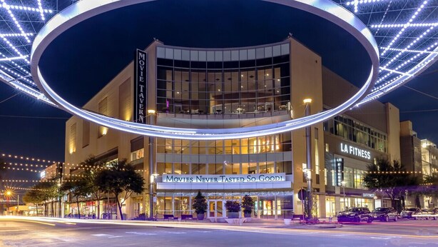 A modern building with a large circular light installation above the entrance. - Fort Worth 2BR/2BA Home w/ Pool + Games | Sleeps 6 (Fort Worth)