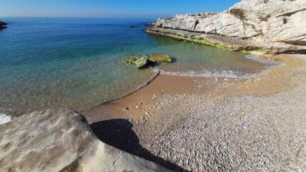 A coastal beach with clear water, pebbly shore, and rocky cliffs. - Nonstop electricity 1 bedroom beachfront apartment (Jabal Lubnan)