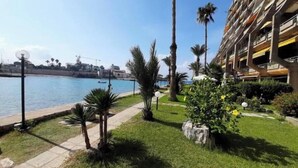 A coastal hotel with a pool, palm trees, and a clear view of the sea. - Nonstop electricity 1 bedroom beachfront apartment (Jabal Lubnan)