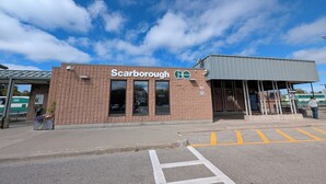 A building with a sign reading "Scarborough." - Cozy 2-Bedroom Basement Apartment In Toronto (Toronto)