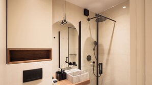 A modern bathroom with a glass-enclosed shower, a wooden vanity, and a built-in sink. - Terrace Haven Hvar (Hvar)