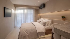 A modern bedroom with a bed, bedside table, and a TV mounted on the wall. - Terrace Haven Hvar (Hvar)