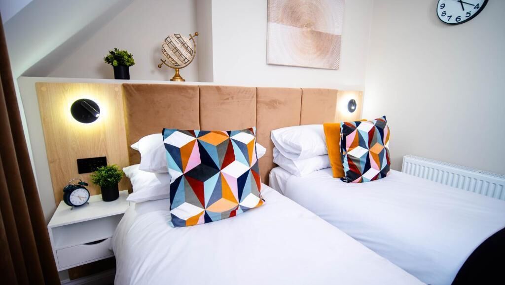 Deluxe Double or Twin Room | Desk, laptop workspace, blackout drapes, iron/ironing board