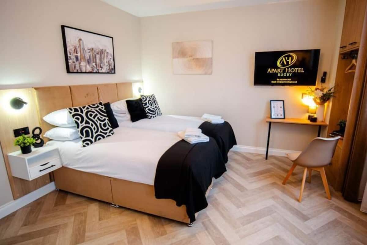 Deluxe Double or Twin Room | Desk, laptop workspace, blackout drapes, iron/ironing board