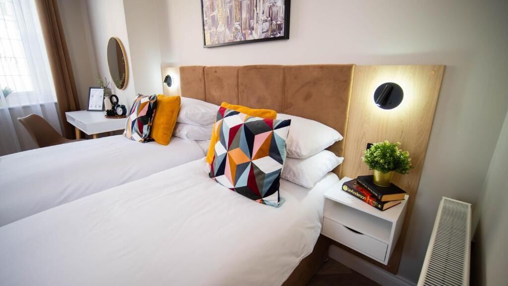 Deluxe Double or Twin Room | Desk, laptop workspace, blackout drapes, iron/ironing board