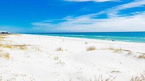 A beach with white sand and clear blue sky. - Beachfront Condo at Beach Club - Large Balcony! (Gulf Shores)