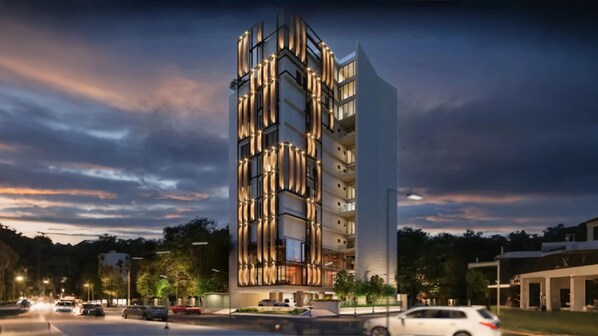 Un immeuble moderne à plusieurs étages, doté d’une façade au design original, caractérisée par des lignes verticales et un mélange de panneaux de verre et de panneaux pleins.