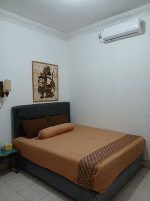 Desk, laptop workspace, bed sheets -  Ndalem Surya Malioboro (Yogyakarta)