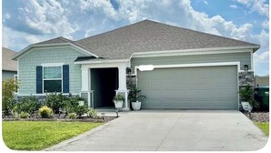 A single-story house with a garage, a front porch, and a driveway. - SPRING HAVEN RETREAT! A BEUTIFULL ANDSPOTLESS!! (Newberry)
