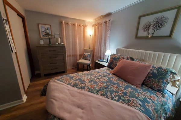 The full bedroom has a double closet, 2 windows,a dresser and 2 end tables.