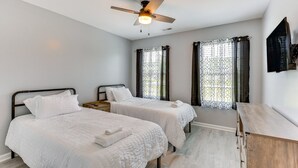 A bedroom with two beds, a ceiling fan, and a wooden dresser. - Country lifestyle w/ the beaches (Bolivia)