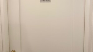 A closed white door with a gold handle and a label reading "GONDOLA NEST".