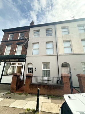 A multi-story building with a ground-floor shop named 'The King Charles.' - Cosy Studio Near Goodison & Anfield, Liverpool (Liverpool)
