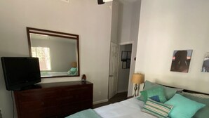A bedroom with a bed, a dresser, a television, a ceiling fan, and a mirror. - Best of both worlds, nature and Chambers landing (Tahoma)